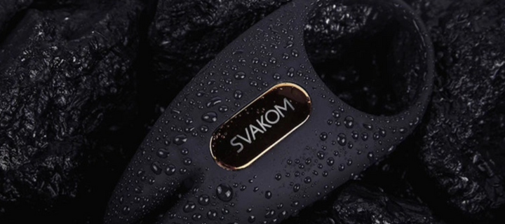 SVAKOM vibrating ring with waterproof design, displayed on textured dark fabric.